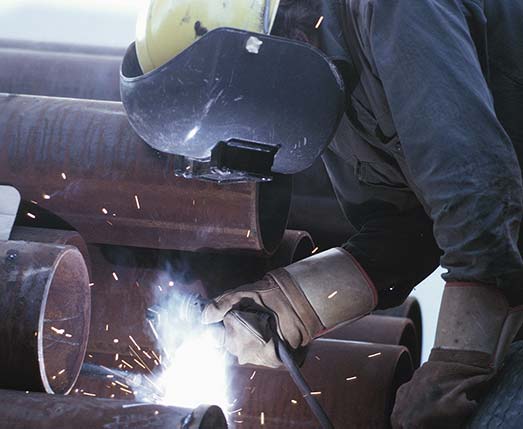 person using a welder